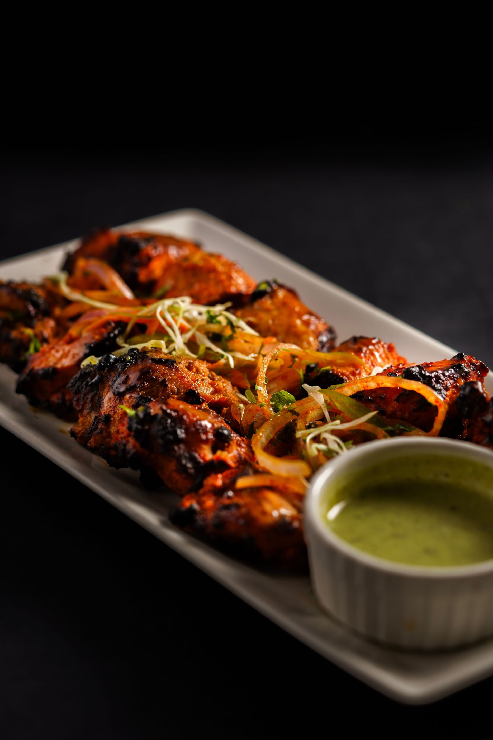 Juicy grilled chicken tandoori served with fresh mint chutney and herbs.